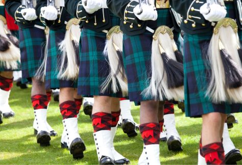 Scottish military band marching on parade. A close up photo of just their kilts.