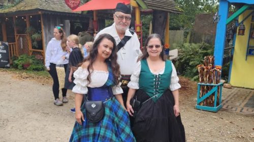 2 female and one male renaissance festival participant at a renaissance festival.